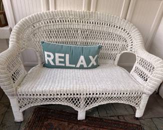 White wicker settee with cushions