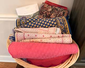 Basket of quilted table linens and tablecloths