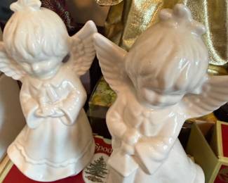 Angel figurine with flute in burgundy robe