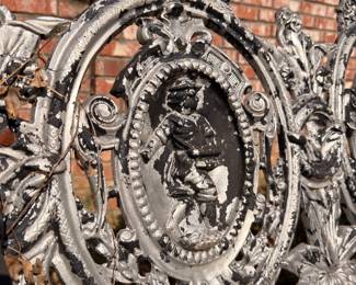 Cast iron garden bench figural medallion detail