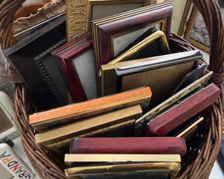 Basket of gold and wood picture frames