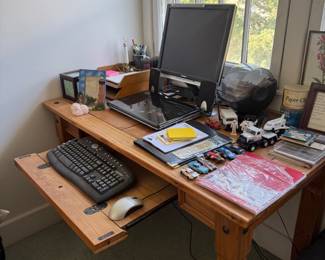 Wood desk with monitor and office accessories
