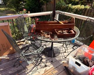 Wrought iron patio table and chairs with antique toolbox