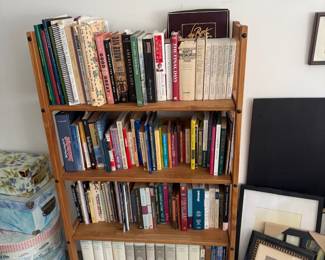 Wood bookshelf with books and framed art