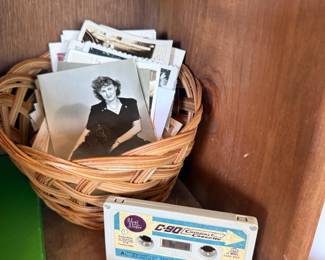 Basket of vintage photographs and cassette tapes