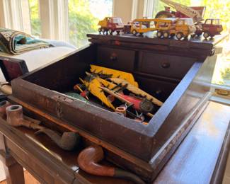 Antique wood chest with vintage toys and pipes