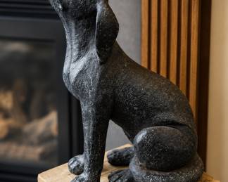 Dig sculpture on wood pedestal