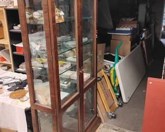 A lighted glass and mahogany color display case
