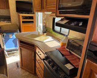 Kitchen area, one of 3 TVs