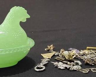 Green hen on nest full of vintage jewelry