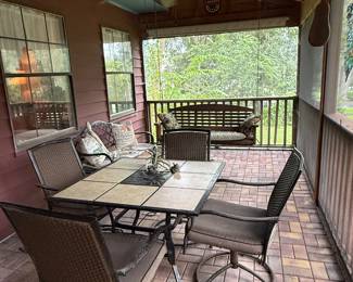 tile-topped dining table with dark metal swivel chairs