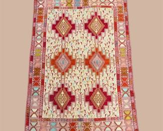 Red and Ivory Geometric Area Rug – Bold diamond motifs in red and coral tones create a distinctive geometric design with a decorative border.