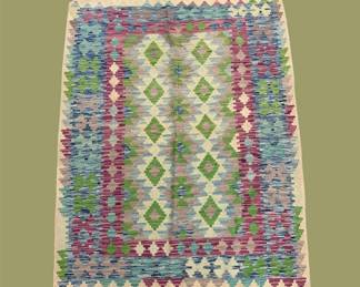 Pastel Geometric Area Rug – Green, blue, pink, and lavender tones create a colorful geometric pattern with a softer feel.