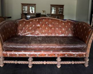 Spanish Colonial Style Leather Upholstered Sofa with Heavily Distresses Patinated Leather Seat, Turned Wood Frame with Hair on Hide Surround. Measures 80" W x 40" D. Photo 1 of  4. 