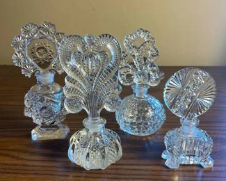 p Set of Four Vintage Cut Glass Perfume Bottles with Intricate Stoppers H 7in, 6.5in, 6in, and 5in