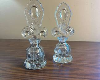 p air of Clear Glass Perfume Bottles with Ornate Fleurdelis Shaped Stoppers