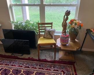 TV, computer monitor, vintage chair, vintage side table, baskets, lamp