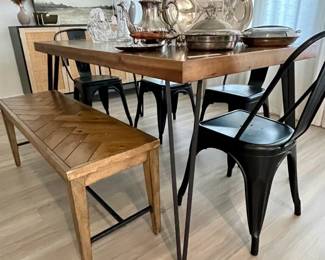 silver serving ware, slat bench and table, black metal chairs