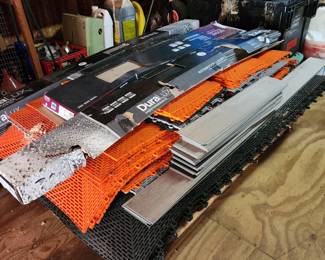 Various construction materials, including orange interlocking panels