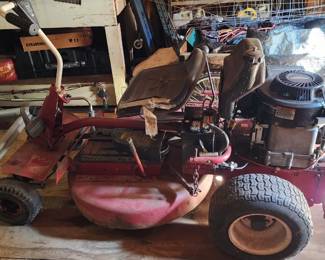 Vintage Swisher Ride King Big Mow riding lawn mower with a worn seat