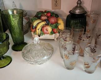 Depression glass items, including green grape-patterned vases, frosted gold-leafed tumblers