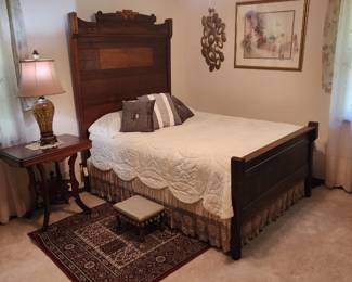  Vintage Dark wooden full-size bed with a carved headboard