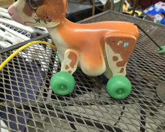 Vintage Fisher-Price #132 Pull Toy Vintage Fisher-Price #132 pull-along cow/calf toy with original green wheels and yellow pull cord. Colorful lithographed details and classic FP logo. Shows normal age and play wear. Great vintage toy collectible.