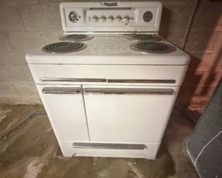 Vintage Monarch Electric Range / Stove Vintage Monarch electric range with white porcelain/enamel finish, chrome accents, four coil burners and original Art Deco-style Monarch controls and hardware. Original Monarch identification plate remains inside the lower compartment. Wonderful vintage kitchen appliance with great period character. Shows age-related wear and surface soiling from storage. Untested; working condition unknown. Buyer responsible for removal.