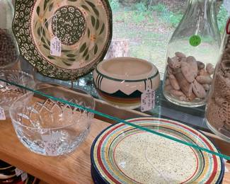 Top shelf next to milk bottle, small bowl appears to be Native American