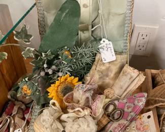 Arrangement of antique sewing items in basket