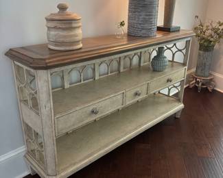 Sarreid Ltd. Quatrefoil Console Table Beautiful, substantial console table by Sarreid Ltd. featuring a distressed finish, quatrefoil detailing, three drawers and open shelving. A gorgeous statement piece for an entryway, living room or dining area. 