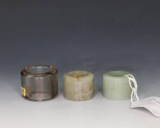 Lot of three Chinese archer rings in rutilated quartz and jade