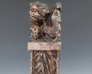 Hardstone Chinese seal with a carved Foo Dog playing with a ball on top of a bamboo stand
