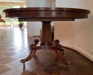 Mahogany Dining / Entry Table with Starburst Inlay with Brass Claw Caps & Casters Attributed to Burton Ching. Measures 50" D x 29" H with 26" Clearance. Photo 1 of 4.  