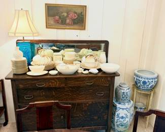 Huge set of Lenox china on top of a quarter sewn oak buffet with beveled glass mirror.