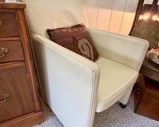 Pair of leather chairs on casters.