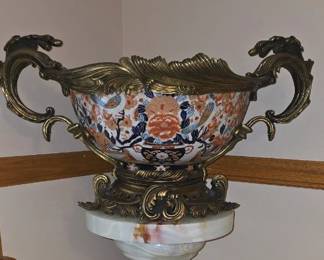 Vintage bronze-mounted Japanese Imari porcelain centerpiece bowl featuring detailed [Rococo-style ormolu scrollwork handles and a matching footed base.