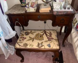 Drexel French Provincial Vanity Desk with Bench:  Mahogany French Provincial kneehole vanity/writing desk with marbleized laminate top, three drawers and cabriole legs, paired with matching bench upholstered in a crewel-style floral fabric; drawer stamped 'by Drexel Reg. Trade Mark'