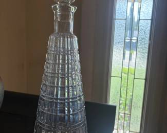 Cut crystal ship's decanter with stopper:  Tall tapered clear glass/crystal decanter with paneled diamond-cut design and matching stopper; small illegible label on the neck.