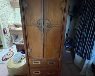 Hickory Manufacturing Co. Campaign-Style Chest:  Tall campaign/Chinoiserie style chest with round brass medallion pulls and quatrefoil door hardware, mixing drawers and a cabinet door; bears brass 'Hickory Manufacturing Co. Since 1911' medallion 