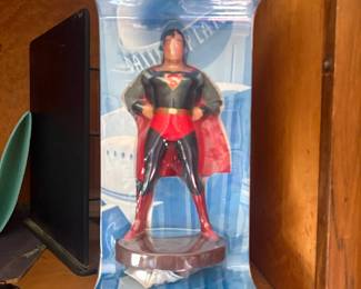 Superman 'Daily Planet' Statue (Sealed):  Vinyl/resin Superman figure on Daily Planet-themed backer card, still sealed in shrink wrap