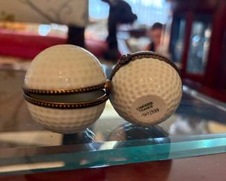 Limoges golf ball trinket box (plain):  Golf-ball-shaped Limoges porcelain box with dimpled texture, brass hinge and clasp, cream interior.