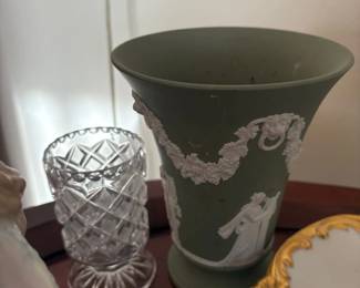 Sage green jasperware trumpet vase (Wedgwood-style):  Large flared trumpet-form vase in sage green jasperware with applied white classical relief figures, grape/leaf swags, and ram/lion mask ring handles.