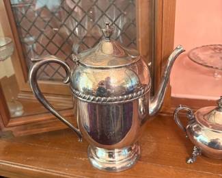 Silverplate Footed Teapot:  Silverplate hinged-lid teapot/coffee pot with gadroon rim border, scroll handle, and pedestal 