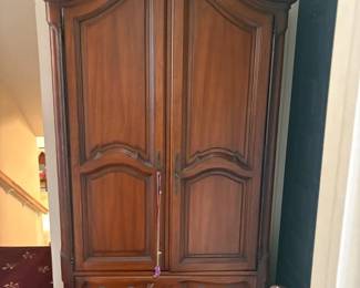 Drexel French Provincial Bonnet-Top Armoire:  Large cherry/fruitwood French Provincial style armoire with arched bonnet top, two paneled doors and two lower drawers; drawer stamped 'by Drexel Reg. Trade Mark'