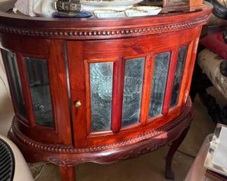 Mahogany demilune curio display cabinet:  Bow-front mahogany display cabinet with beaded trim, beveled curved glass door panels, cabriole legs, and a lower open shelf