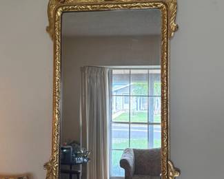 Gilt Chippendale-Style Eagle Crest Wall Mirror:  Large gold gilt wall mirror with carved eagle-head crest, central shell motif, acanthus leaf scrollwork frame, beveled glass