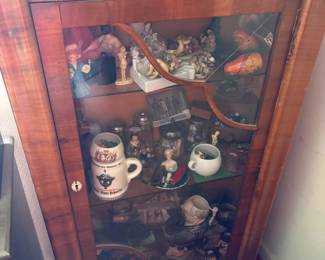Single-door display cabinet, shaped beveled glass panel, burl walnut veneer, bun feet; likely Continental European, mid-20th c.
