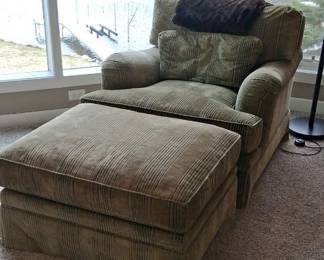  oversized green upholstered armchair with a matching ottoman