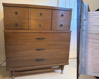 high chest dresser features a two-tone walnut finish with distinctive brass-toned drawer pulls and tapered legs MCM